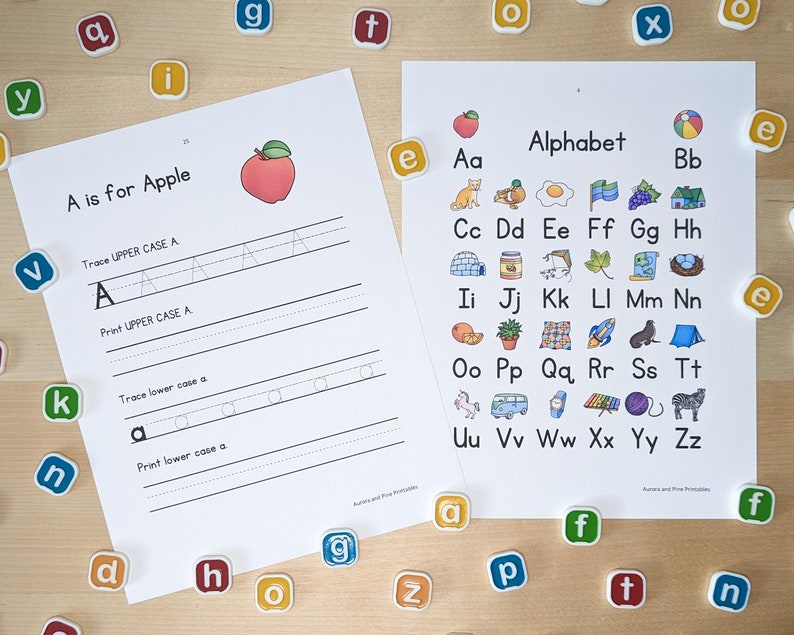 May include: A printable worksheet for learning the alphabet. The worksheet features a red apple with a green stem and leaf. The letter A is written in uppercase and lowercase with lines for tracing and printing. The alphabet is displayed with a picture for each letter.