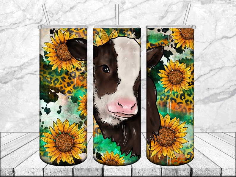 May include: A stainless steel tumbler with a design featuring a brown and white calf, sunflowers, and a leopard print pattern.