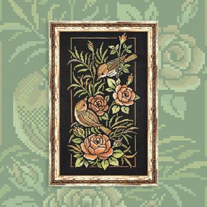 May include: Framed cross-stitch artwork featuring two birds perched among peach-colored roses and green foliage against a black background. The artwork is enclosed in a gold-toned frame with a cream-colored border, creating a classic, decorative piece.