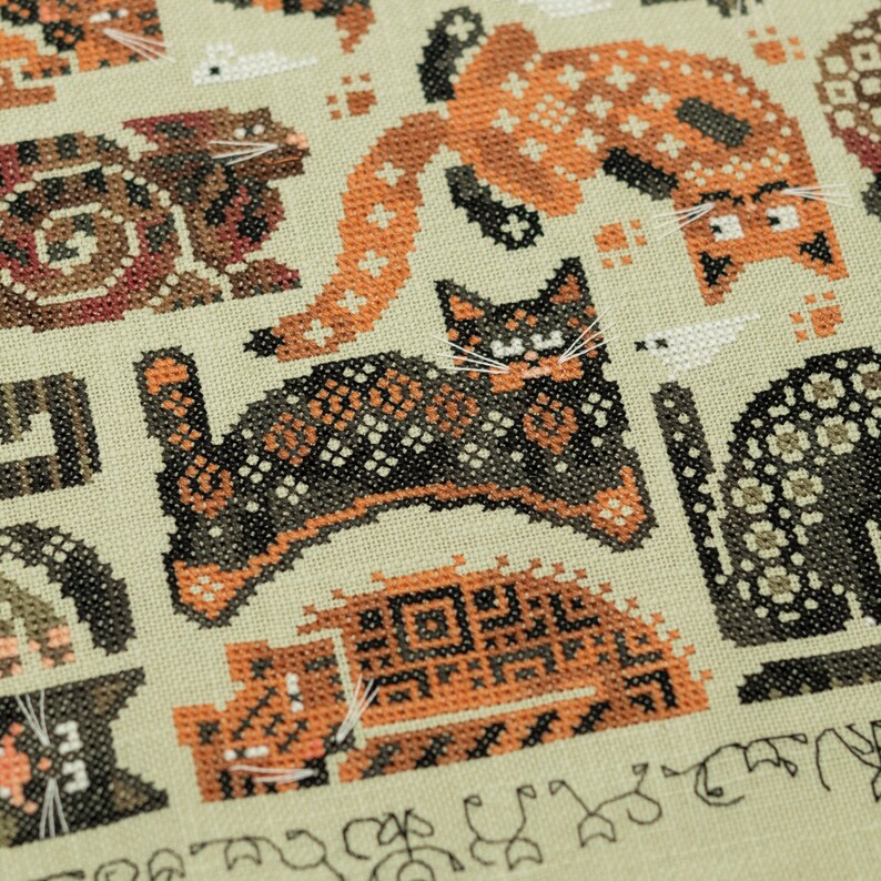 May include: Cross-stitch pattern featuring a variety of cats in different poses and colors. The cats are stitched in a detailed and intricate style, with a variety of textures and patterns. The background is a light beige color.