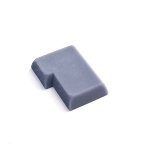 May include: A gray plastic puzzle piece shaped like the number one.