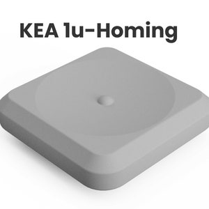 May include: A gray square-shaped button with a small round indentation in the center. The text "KEA 1u-Homing" is printed above the button.