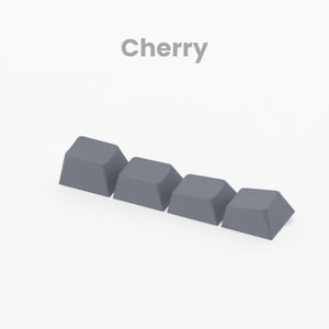 May include: Four gray keycaps arranged in a row, with the word "Cherry" above them. The keycaps are a muted gray color and have a slightly angled top surface. The word "Render" is at the bottom.