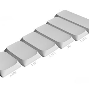 May include: A set of six blank, light gray mechanical keyboard keycaps arranged in a diagonal row. Each keycap is labeled with its specific size in units, ranging from 1.25U to 2.75U. The text *Render is visible in the bottom left corner.