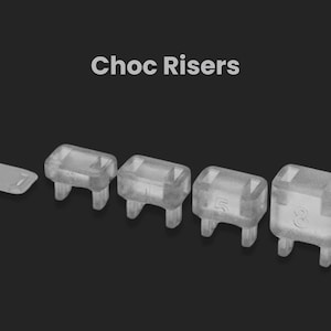 May include: Four clear plastic risers for elevating a keyboard. The risers are labeled 1, 2, 3, and 4, indicating their height.  The risers are designed for use with mechanical keyboards.