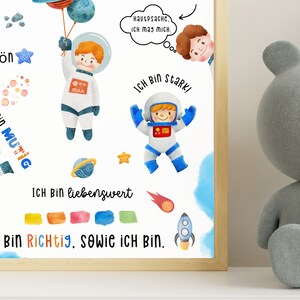 May include: A watercolor illustration of an astronaut with a blue and white spacesuit. The astronaut is holding a blue balloon with stars. The illustration includes the text "Ich bin sch&ouml;n", "Ich bin mutig", "Ich bin stark", "Ich bin liebenswert", and "Ich bin richtig, sowie ich bin".