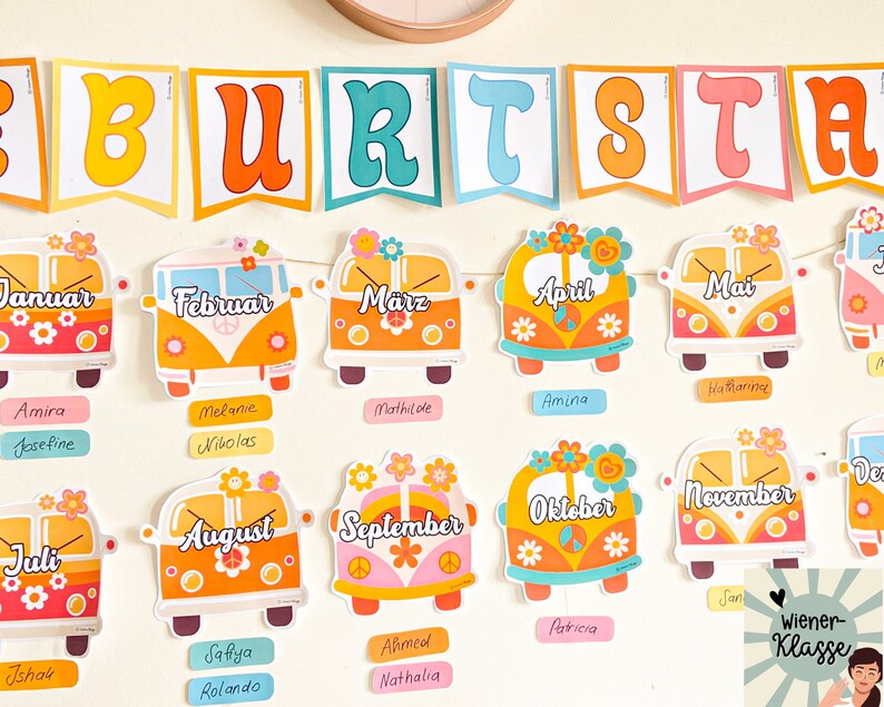 May include: A colourful classroom chart with a banner that reads "BURTSTA" and features a VW bus for each month of the year. Each bus has a flower design and the month's name in German. Below each bus are name tags with names written in different languages.