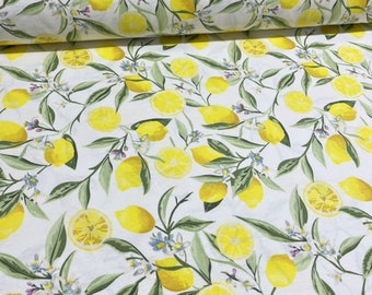 May include: White fabric with a repeating pattern of yellow lemons, green leaves, and small blue flowers. Some lemons are whole, while others are sliced, creating a fresh, summery design. The fabric is likely cotton or a similar material.