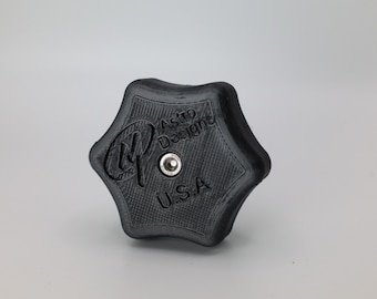 May include: A black plastic star-shaped knob with a silver screw in the center. The knob has the text "Astro Designs" and "U.S.A." printed on it.