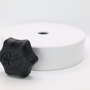 May include: A black plastic knob with a star shape and the text "Astro Designs USA" printed on it.