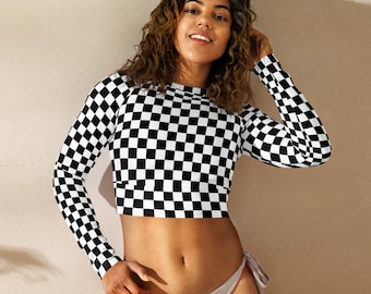May include: A black and white checkered long-sleeve crop top with a high neckline. The top is made of a stretchy, comfortable fabric and has a relaxed fit.