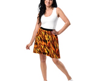 May include: A woman wearing a white tank top and a short, flared skirt with a flame pattern in shades of orange and yellow. The skirt has a black waistband.