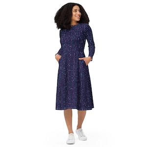 May include: A long-sleeved midi dress with a dark blue background and a pattern of small, colorful dots. The dress has a round neckline and pockets on the sides.