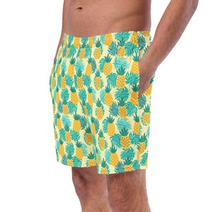 May include: Yellow and green patterned swim trunks with a pineapple design.