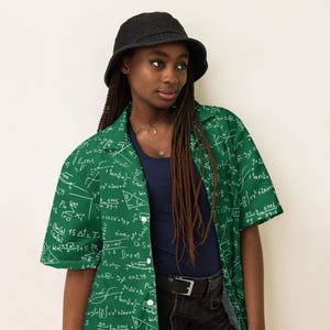May include: A green button-up shirt covered in white mathematical equations and symbols. The shirt is worn with a dark blue shirt underneath and a black bucket hat. The shirt's design features various formulas and geometric shapes.