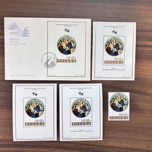 May include: A collection of Polish stamps and an envelope. The stamps feature a religious painting within a circular frame, with the text "65+15 POLSKA". The envelope has text in Polish and a logo.
