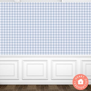 May include: A white wall with blue and white gingham wallpaper. The bottom of the wall has white wainscoting with a raised panel design. The floor is a dark wood.