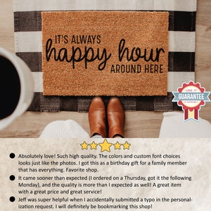 May include: A brown coir doormat with the text "IT'S ALWAYS happy hour AROUND HERE" in black lettering. The doormat has a "LOVE IT - GUARANTEE" tag in the bottom right corner.