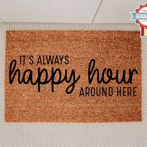 May include: A brown coir doormat with the text "It's always happy hour around here" in black lettering.