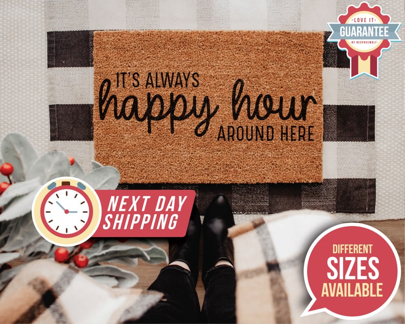 May include: A brown coir doormat with the text "IT'S ALWAYS happy hour AROUND HERE" in black lettering.