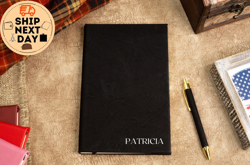 May include: Black leather-bound journal with the name "PATRICIA" embossed in silver lettering.