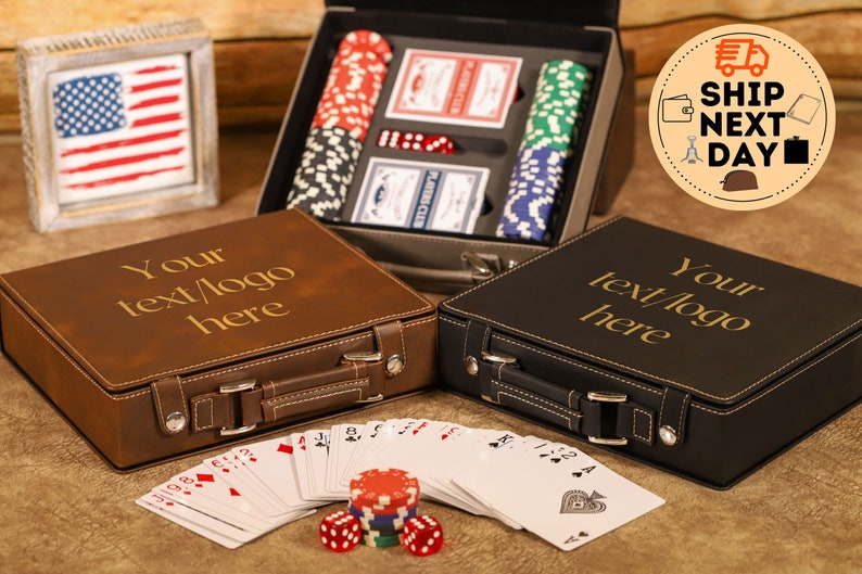 May include: Two personalized leather carrying cases for playing cards and poker chips. The cases are brown and black with gold lettering that says "Your text/logo here". The cases are open and show the contents inside, including playing cards, poker chips, and dice.