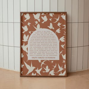 May include: A framed art print with a terracotta background and white bird silhouettes. The print features a quote by Ralph Waldo Emerson. The frame is a dark brown colour.
