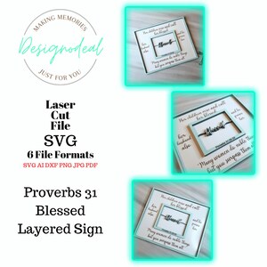 May include: A layered sign with the text "Proverbs 31 Blessed" and a quote from Proverbs 31:28-29, "Many women do noble things, but you surpass them all." The sign is in a light blue color with a white frame and a silver metal word "Blessed" in the center.
