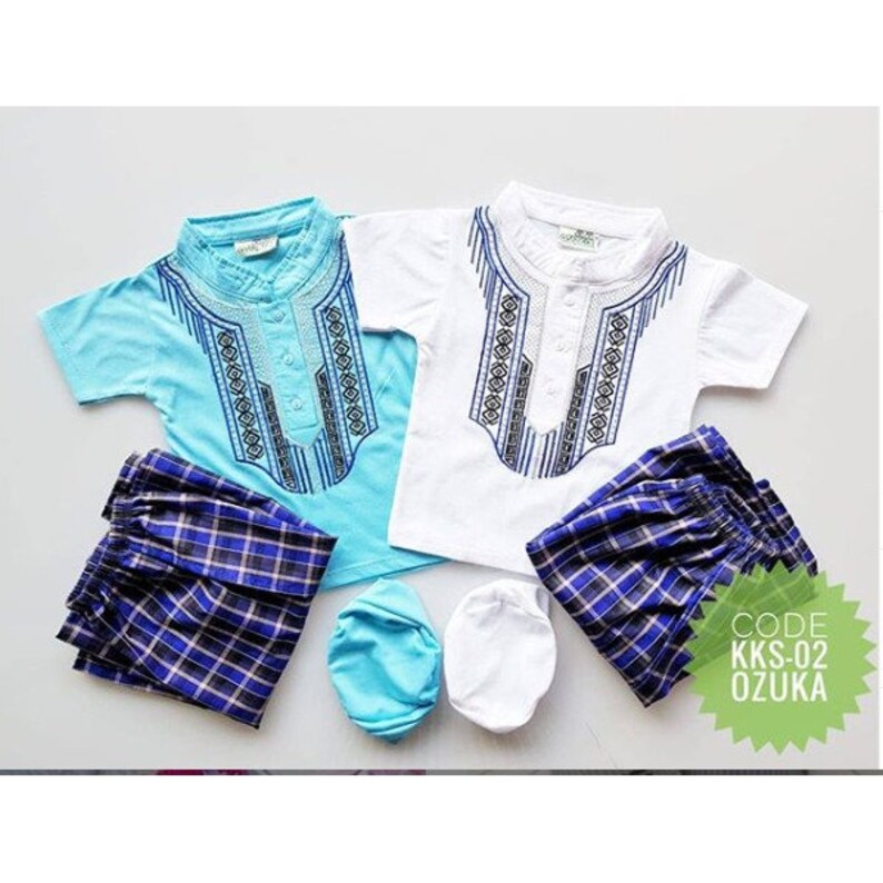 May include: Two sets of children's clothing, one in blue and white and the other in white and blue. Each set includes a short-sleeved shirt with an embroidered design, a pair of plaid pants, and a hat. The code KKS-02 OZUKA is visible in the image.
