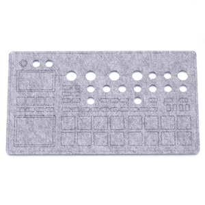 May include: Grey felt mouse mat with a cut-out design of a music production keyboard. The mouse mat has a grey felt surface with a cut-out design of a music production keyboard. The keyboard has a variety of buttons, knobs, and sliders.
