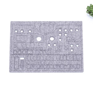 May include: A grey felt mouse mat with a cut-out design of a synthesiser. The mouse mat has a circular knob, buttons, and a keyboard.