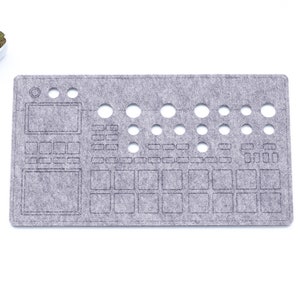 May include: Grey felt mouse mat with a cut-out design of a music production controller. The design includes buttons, knobs, and a screen.