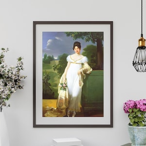 May include: A framed portrait painting of a woman in a white dress with a floral shawl. She is standing in a garden setting with a tree behind her. The painting is in a dark brown frame.