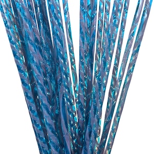 May include: A bundle of blue and teal decorative straws. The straws have a twisted design with a reflective, iridescent quality. The straws are held together, creating a dense, textured appearance. The background is white.