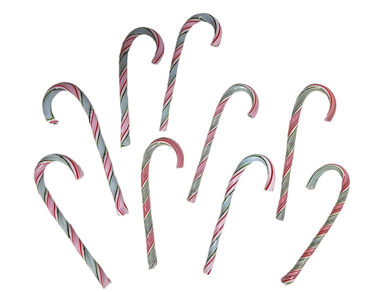 May include: A group of eight candy canes with red, white, and green stripes. The candy canes are arranged in a fan shape.