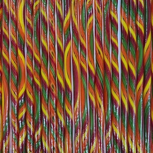 May include: A close-up of a group of colorful candy sticks. The sticks are twisted and have a red, yellow, green, and orange swirl pattern.