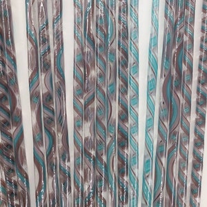 May include: A collection of glass rods with a swirling pattern of teal and brown colors.