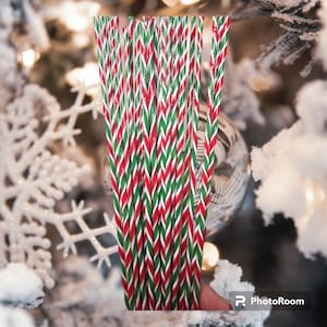 May include: A bundle of red and green striped straws, perfect for adding a festive touch to your holiday drinks.