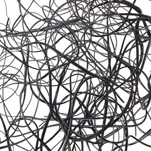 May include: A tangled mass of black electrical wires, creating a chaotic and abstract pattern.