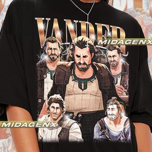 May include: Black t-shirt with a graphic print of five men with the word "VANDER" in gold letters above them. The men are wearing different outfits and have different hairstyles. The word "MIDAGENX" is printed in white letters on the bottom right corner of the shirt.