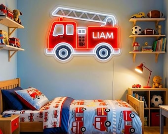 May include: A bright red fire truck neon sign mounted on a blue wall, featuring a white ladder outline and the name LIAM illuminated in white text on the side. The sign has a rectangular body, two circular wheels, and a white glowing border.