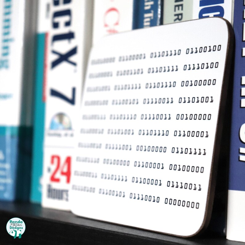 May include: White coaster with a black and white design of binary code. The code is printed in a grid pattern with rows of 0s and 1s.