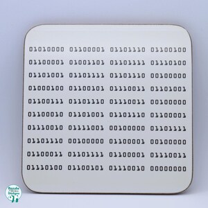 May include: A white square coaster with black binary code printed on it. The code is arranged in rows of eight digits, with each row representing a different number. The coaster is made of a durable material and is perfect for protecting your furniture from spills and scratches.