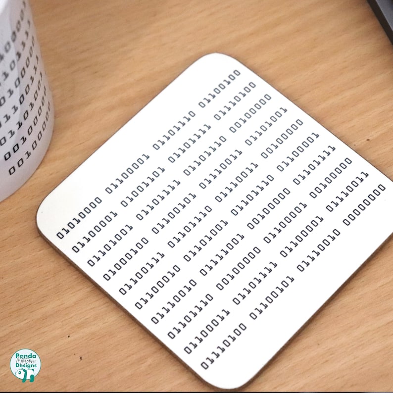 May include: A white coaster with a pattern of black binary code. The code is arranged in rows and columns, creating a visual representation of data.