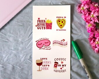 May include: A white card with six Valentine's Day themed illustrations and text. The phrases include "Fries Before Guys," "Pizza is My Valentines," "Why fall in love when you can fall asleep?", "Single Babes Club," "Love Stinks Let's Drink," and "Coffee is My Valentine."