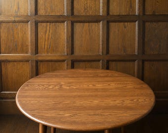 Ercol drop-leaf dining table and two chairs
