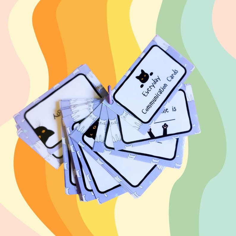 May include: A set of purple cards with black and white cat illustrations. The cards are labeled "Everyday Communication Cards".