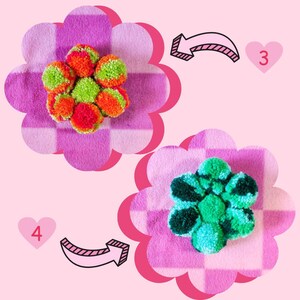 May include: Two colorful pom-pom flowers on a pink and white checkered fabric background. The flowers are made with green, orange, and red yarn.