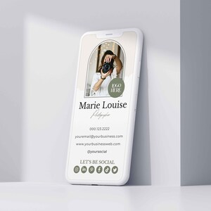 May include: A white smartphone mockup with a digital business card for a photographer. The card features a photo of a woman holding a camera, the text "Marie Louise Photographer", contact information, and social media icons. The text "LOGO HERE" is in a green circle.