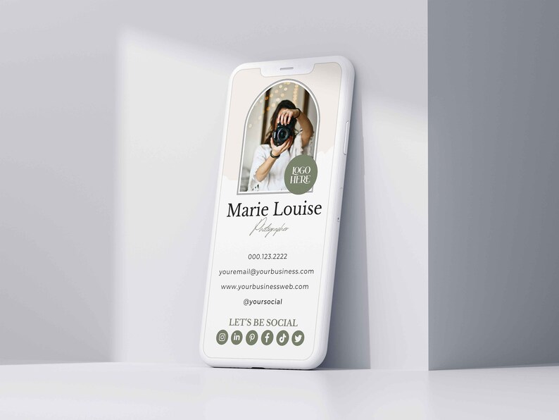 May include: A white smartphone mockup with a digital business card for a photographer. The card features a photo of a woman holding a camera, the text "Marie Louise Photographer", contact information, and social media icons. The text "LOGO HERE" is in a green circle.